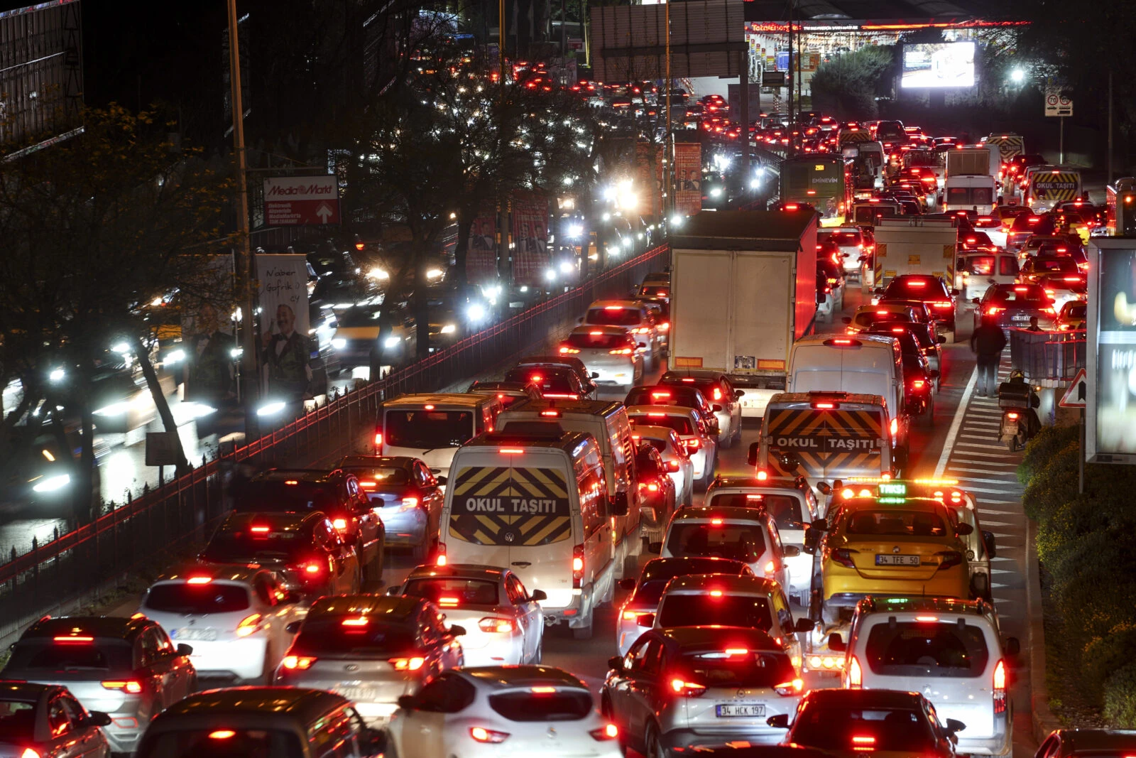 Heavy traffic congestion in Istanbul at night, with long lines of vehicles and red brake lights illuminating the busy streets