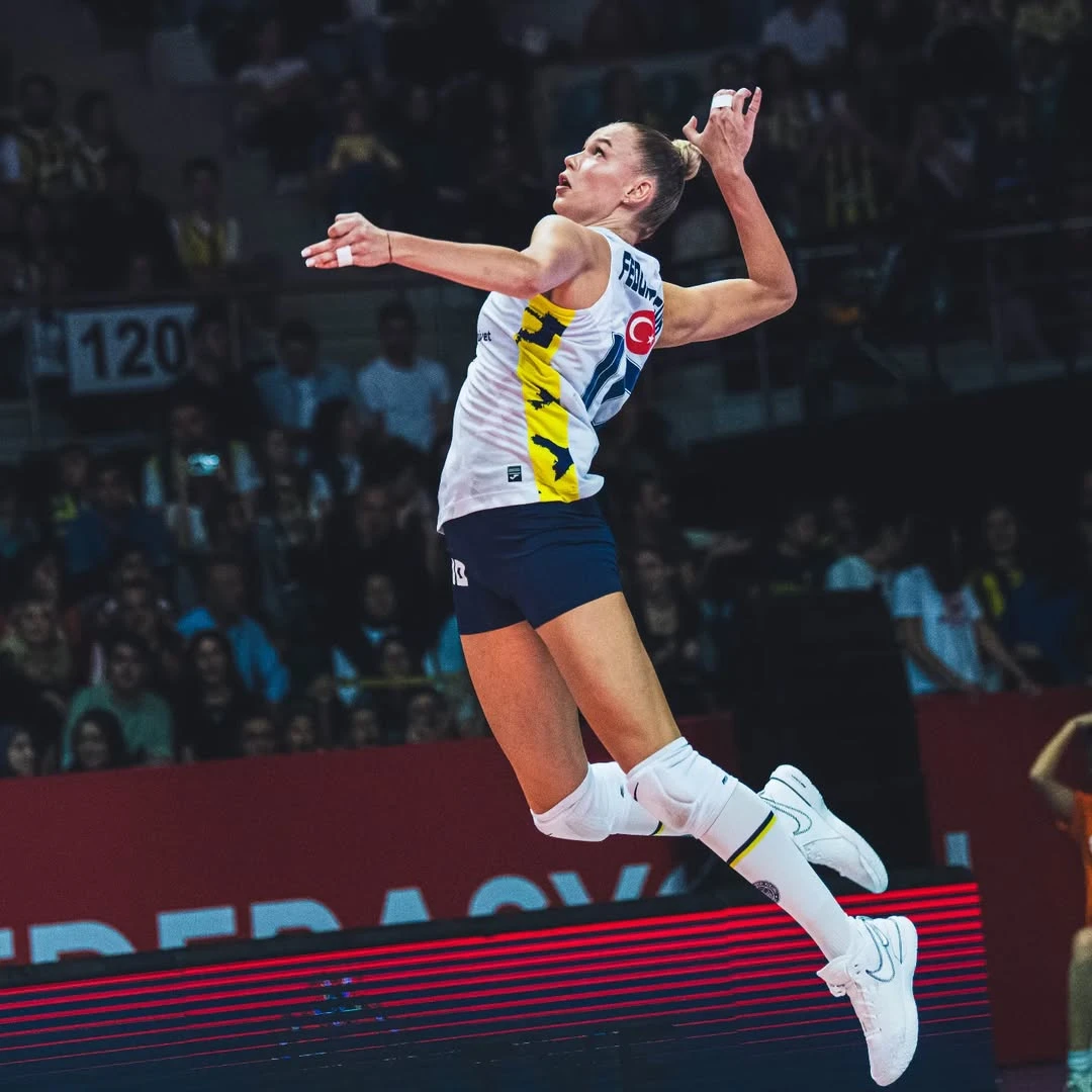 Arina Fedorovtseva in action, executing a powerful jump serve in a Fenerbahce match