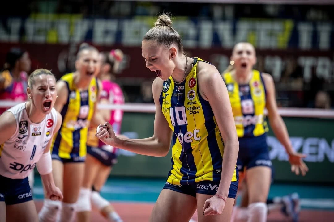 Arina Fedorovtseva passionately celebrates a critical point with her Fenerbahce teammates during a match