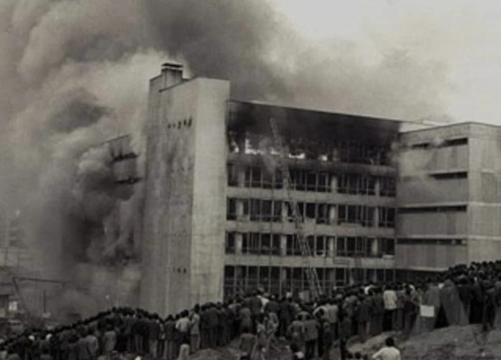 black and white photo shows shopping center burning in Ankara