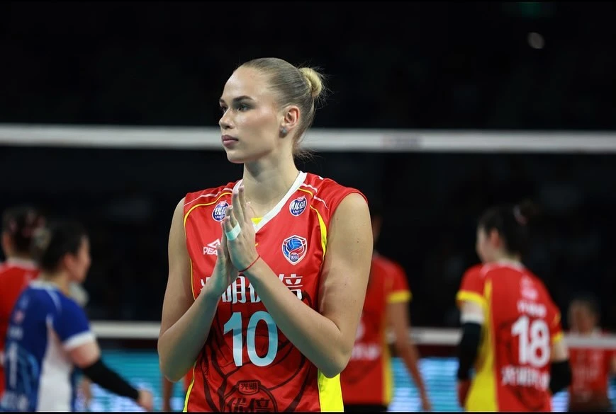 Arina Fedorovtseva claps her hands while representing Shanghai Bright Ubest during a volleyball match