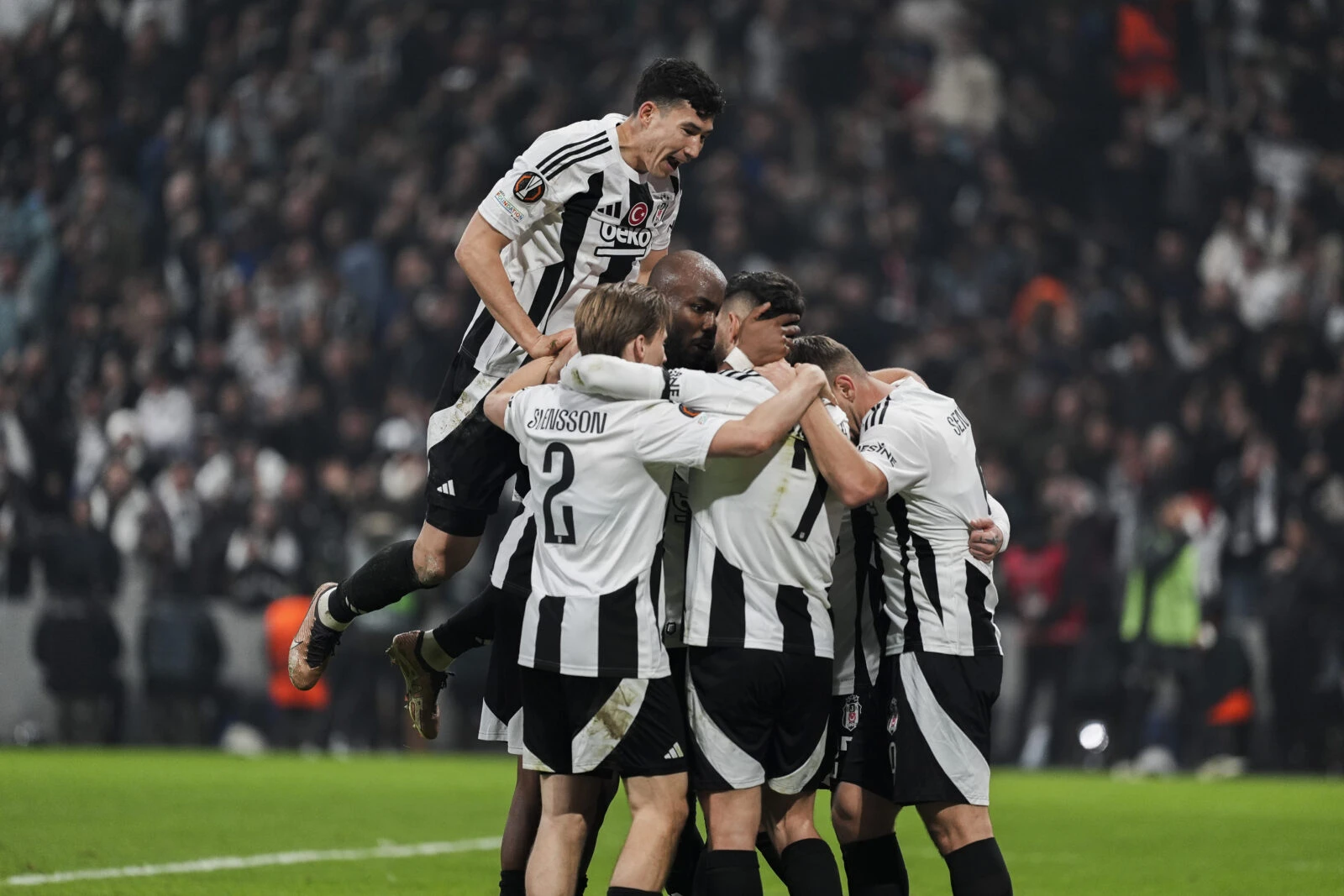 Besiktas players huddle to celebrate a goal