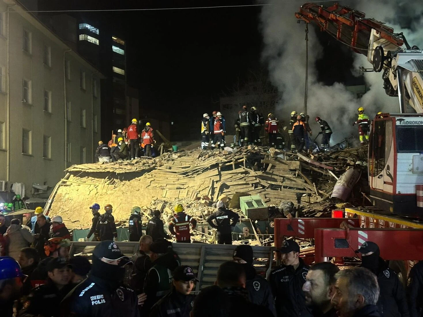 Emergency teams are seen launching a search and rescue operation following the collapse of a three-story building in Konya.