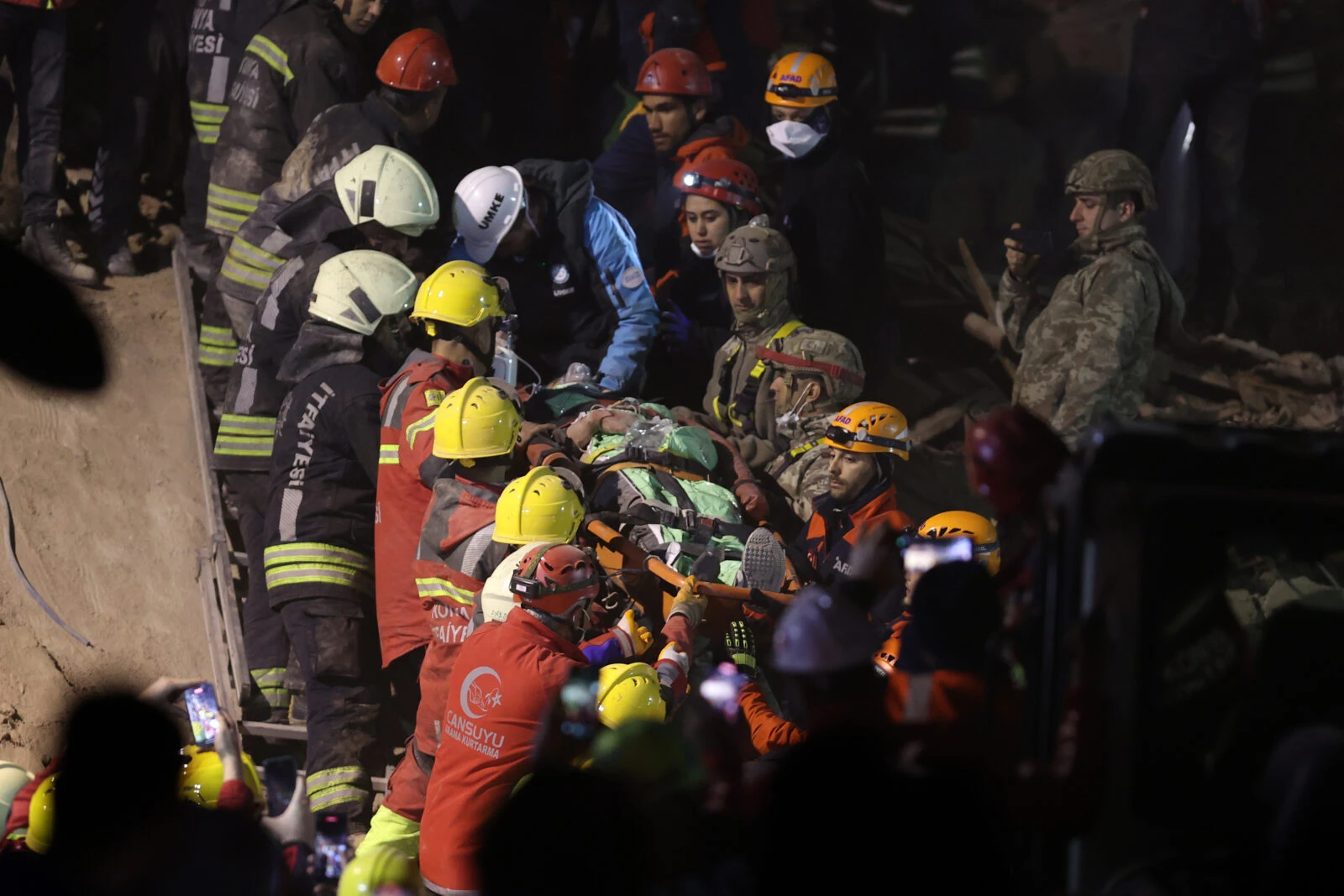 Photo shows Turkish rescue teams pulling out people out of rubbles from a collapsed building.