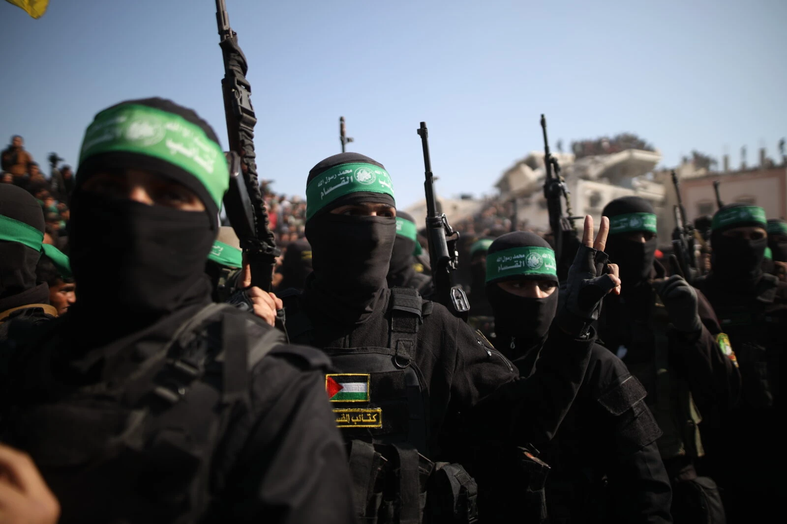 Photo shows Hamas' Al-Qassam Brigades gather outside the ruins of the house of former Hamas leader Yahya Sinwar