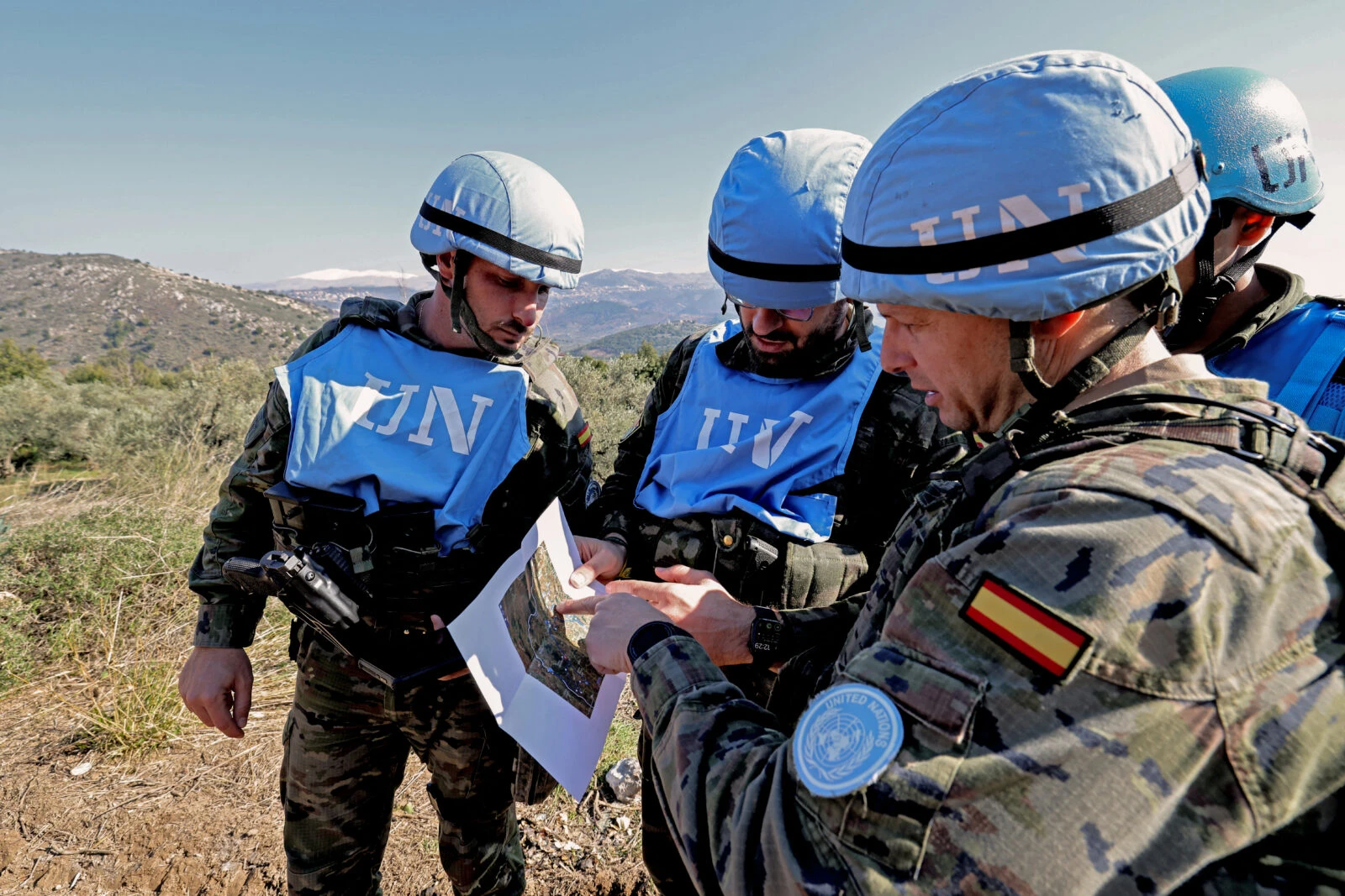 Photo shows UN peacekeeper troops in Lebanon looking at a sheet