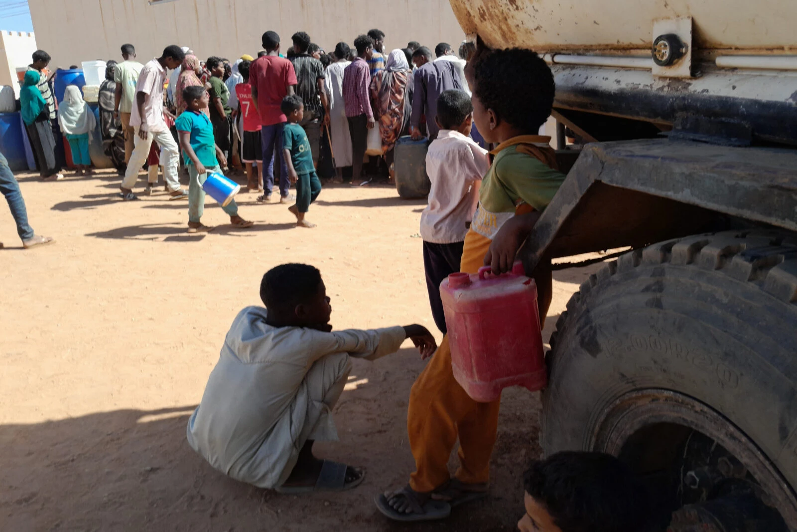 People queue for water in Omdurman