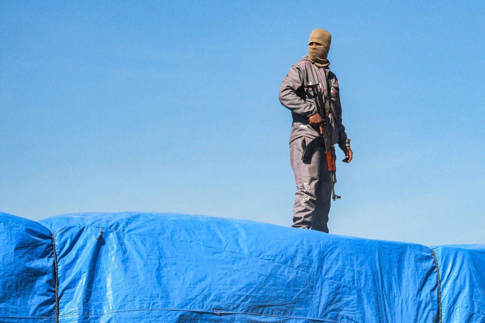 Hamas soldier standing on top of the aid truck