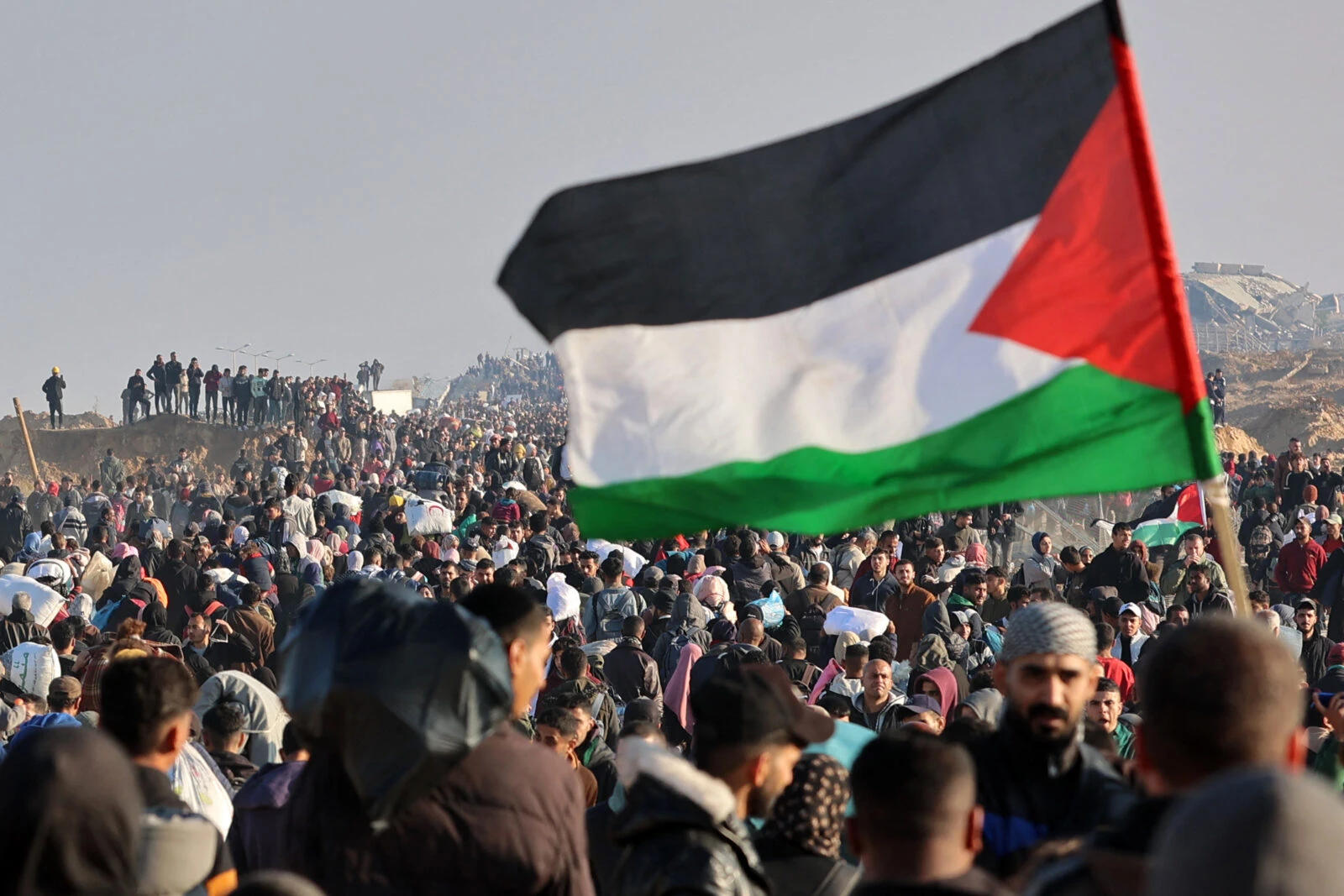 A person waves a Palestinian flag