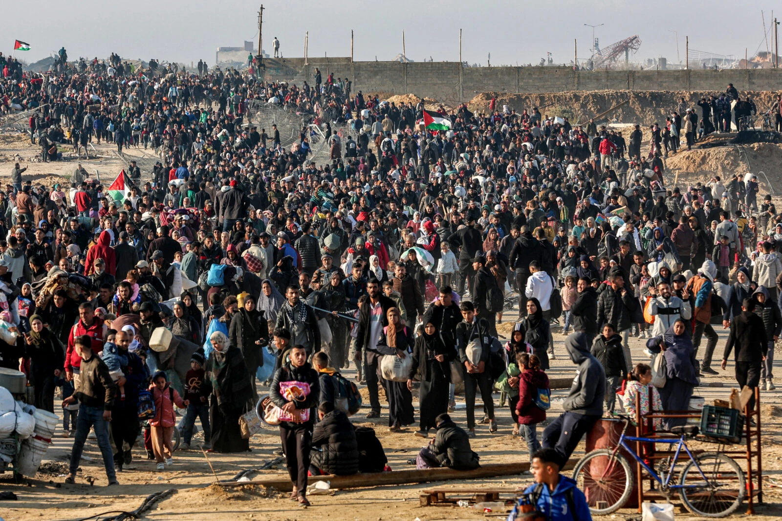 People walk along Gaza's coastal al-Rashid Street to cross the Netzarim corridor