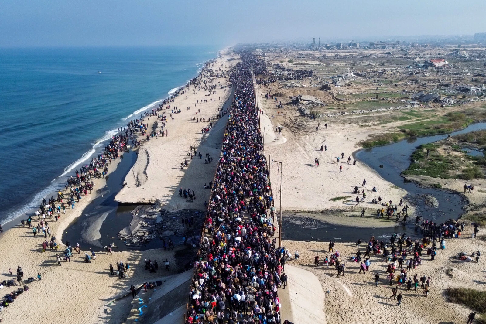 displaced Gazans walking toward Gaza City