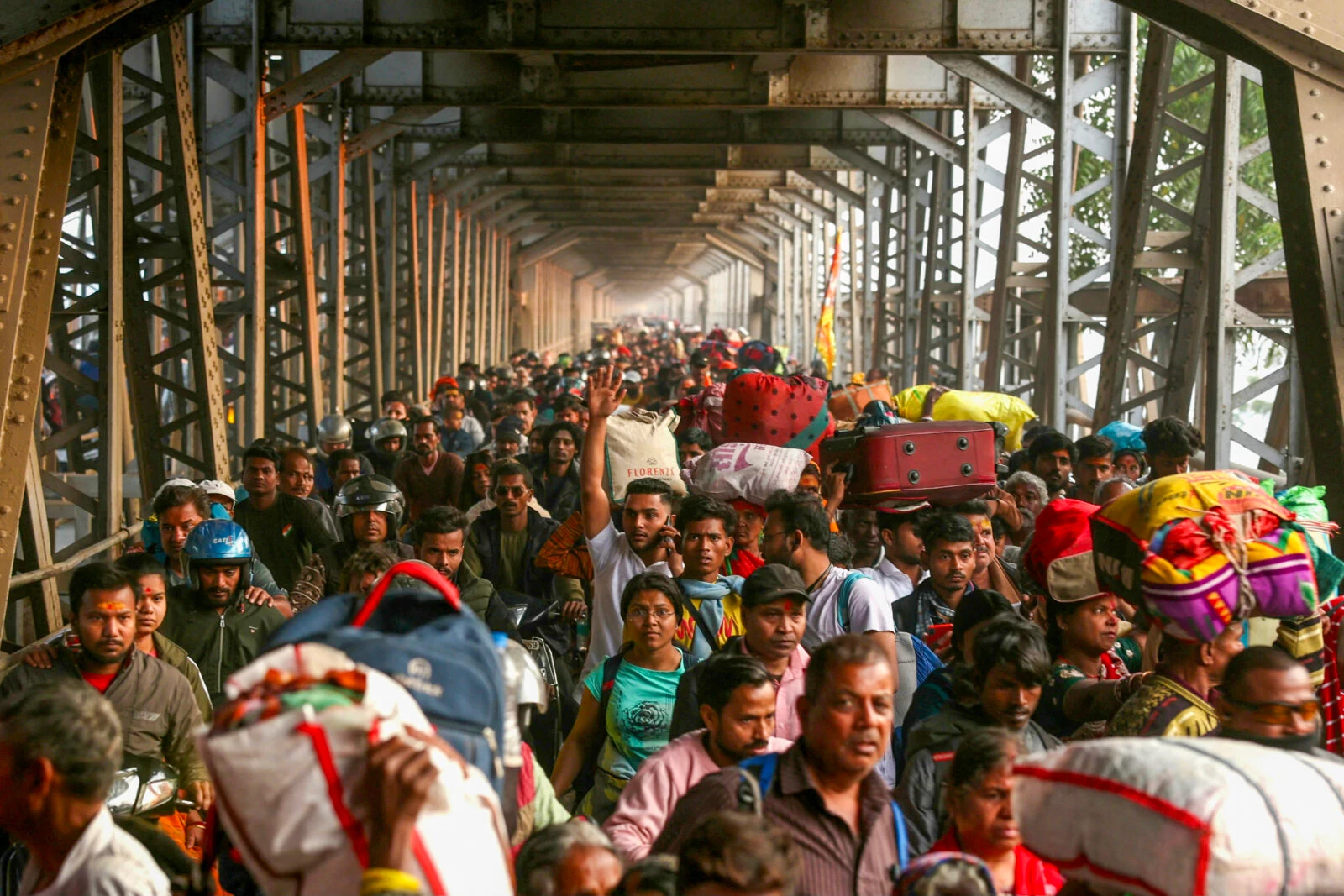 Hindu pilgrims seen walking along the old Yamuna bridge during the Maha Kumbh Mela festival.