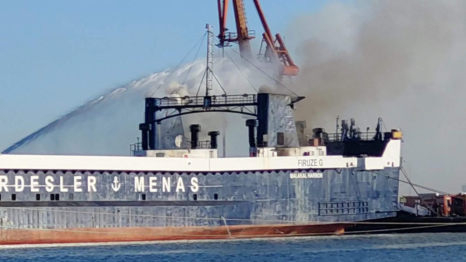 Aerial view of a fire on a ship at Samsun Port, controlled by response teams