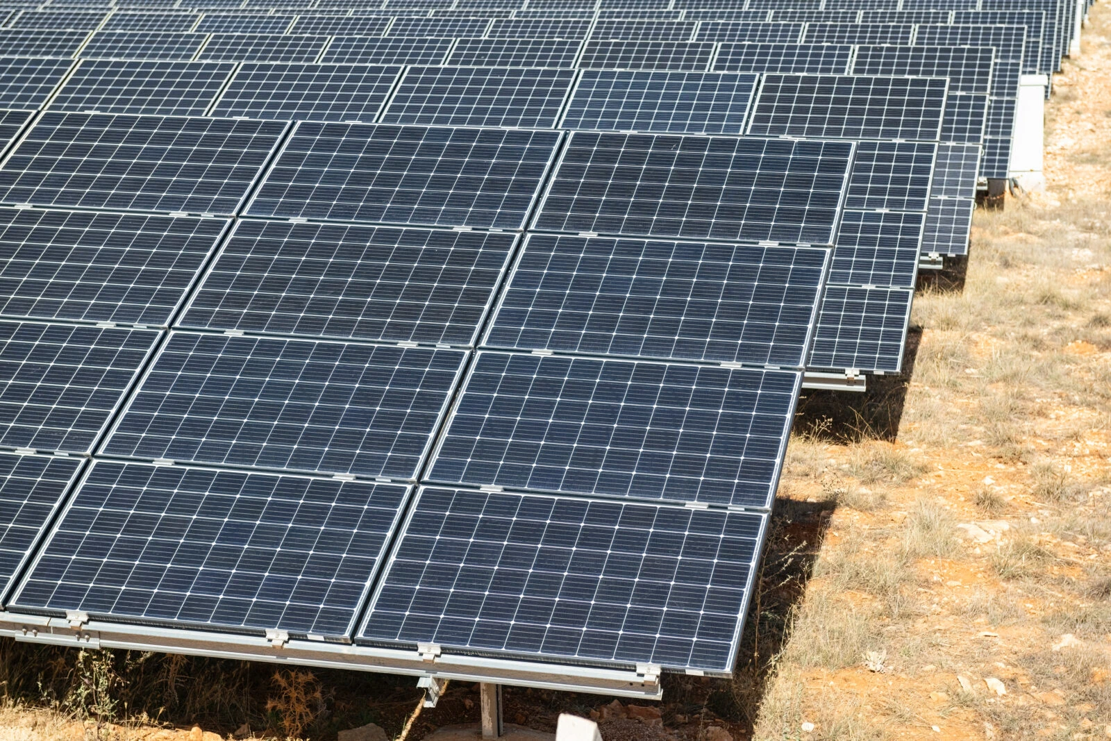 A large array of solar panels installed on dry, rocky terrain somewhere in Türkiye. (Adobe Stock Photo)