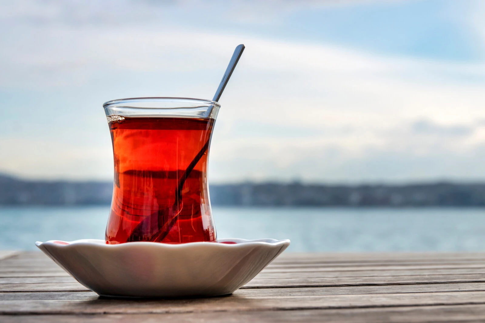 Turkish tea served in the traditional way—steaming hot in a glass on a small saucer. (Adobe Stock Photo)