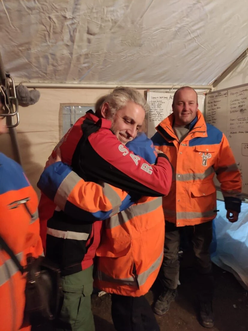 A warm embrace between international SAR members after days of intense earthquake relief efforts