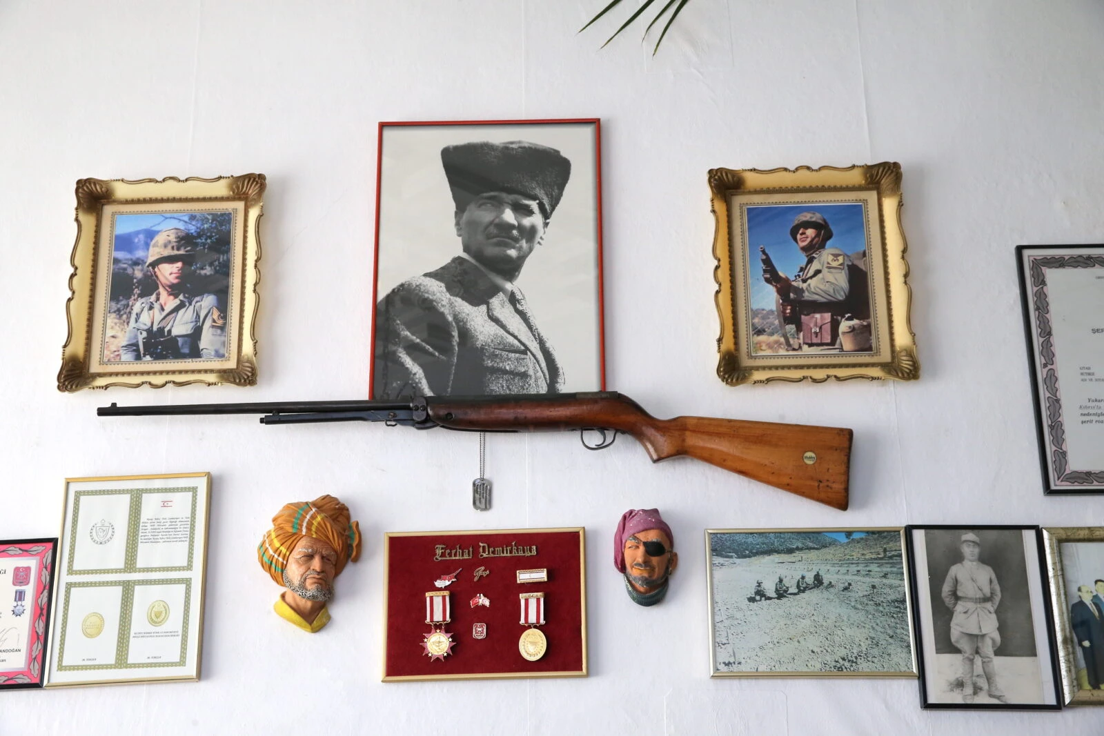 Ferhat Demirkaya, a Cyprus Peace Operation veteran, holds significant memorabilia from the operation, including a rifle, a small figurine, and photos from key locations, which he has kept for 50 years.