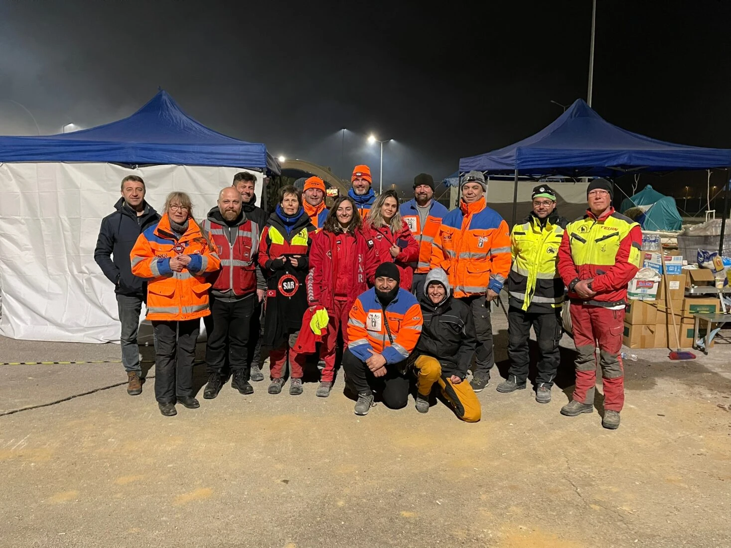 Dutch volunteers and SAR rescue workers pose for a photo before saying goodbye