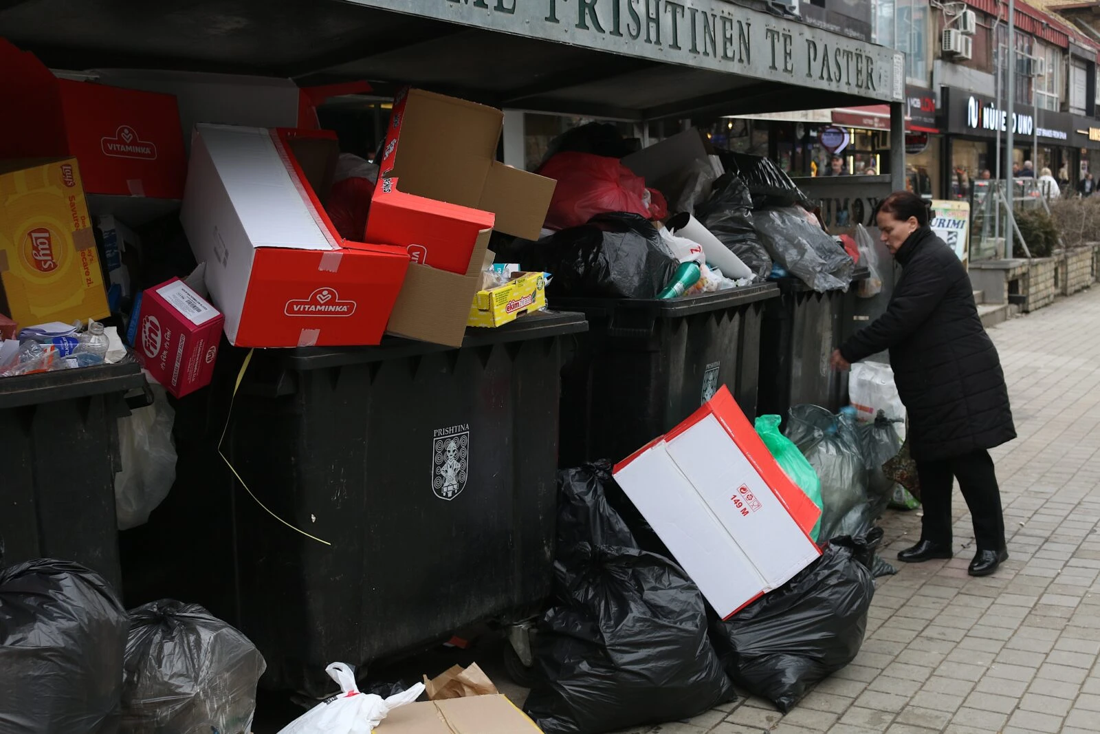 Due to waste management issues in Pristina, Kosovo, some neighborhoods have overflowing trash bins, and many trash cans are not emptied for days