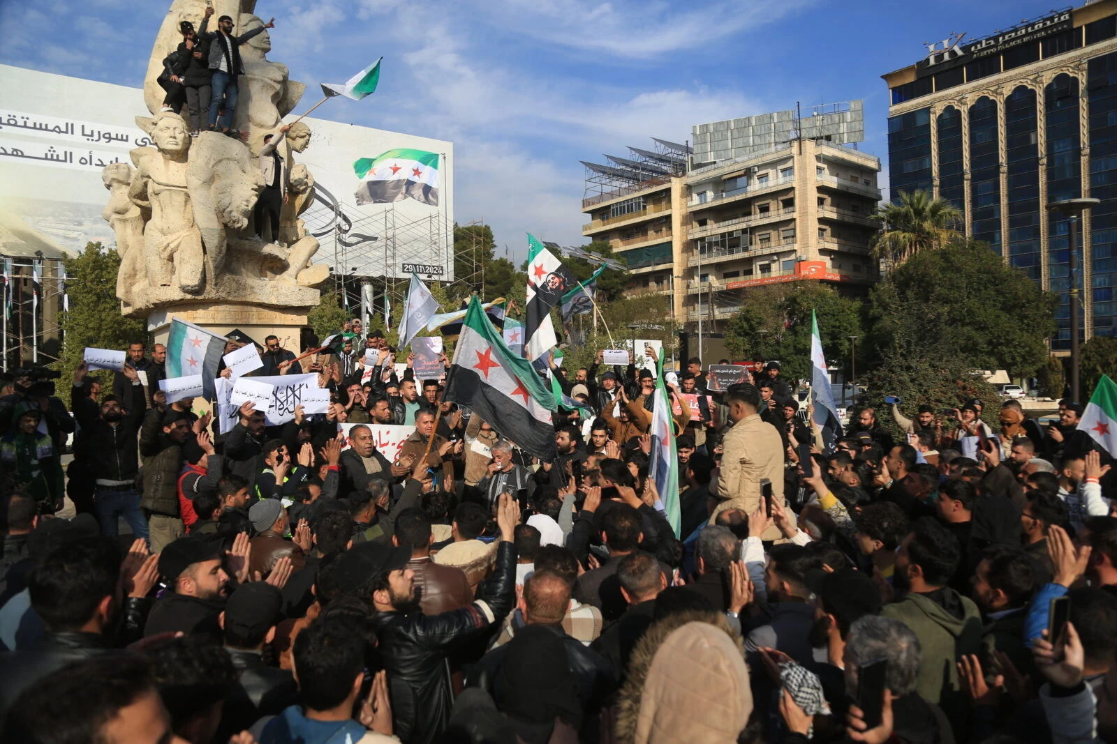 Syrians gather in Sadullah Jabiri Square in Aleppo