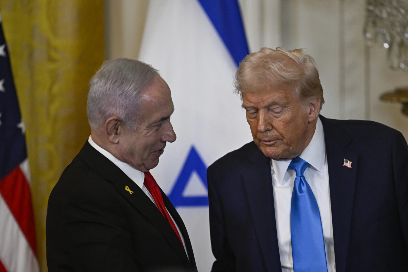 Photo shows us president donald trump leaning towards israel pm netanyahu