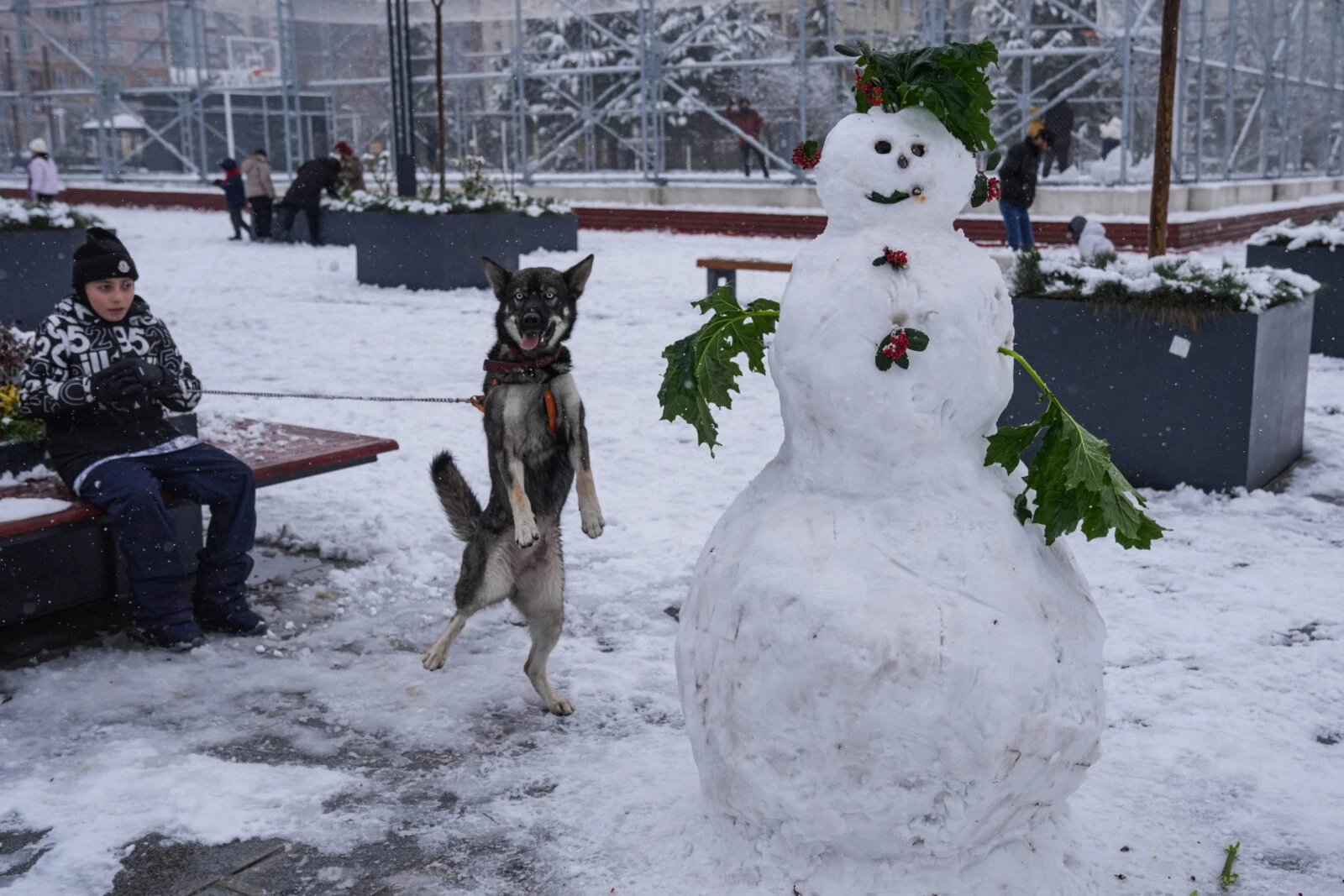 Children playing in the snow in Istanbul, building snowmen after heavy snowfall.