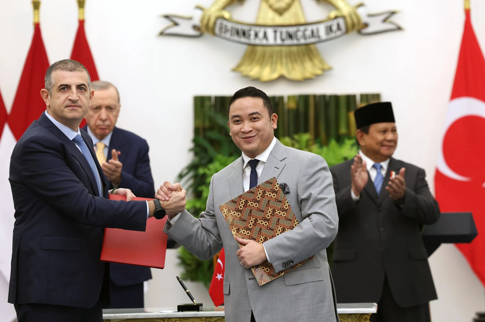 photo shows Haluk Bayraktar shaking hands  after Turkey Indonesia agreement signing