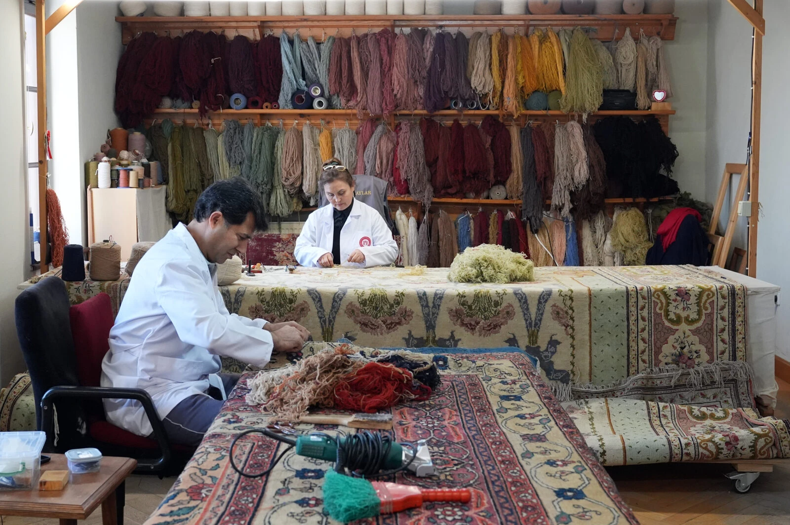 Restoration in progress on two 200-year-old carpets from the Ottoman palace, being prepared for exhibition in Istanbul.