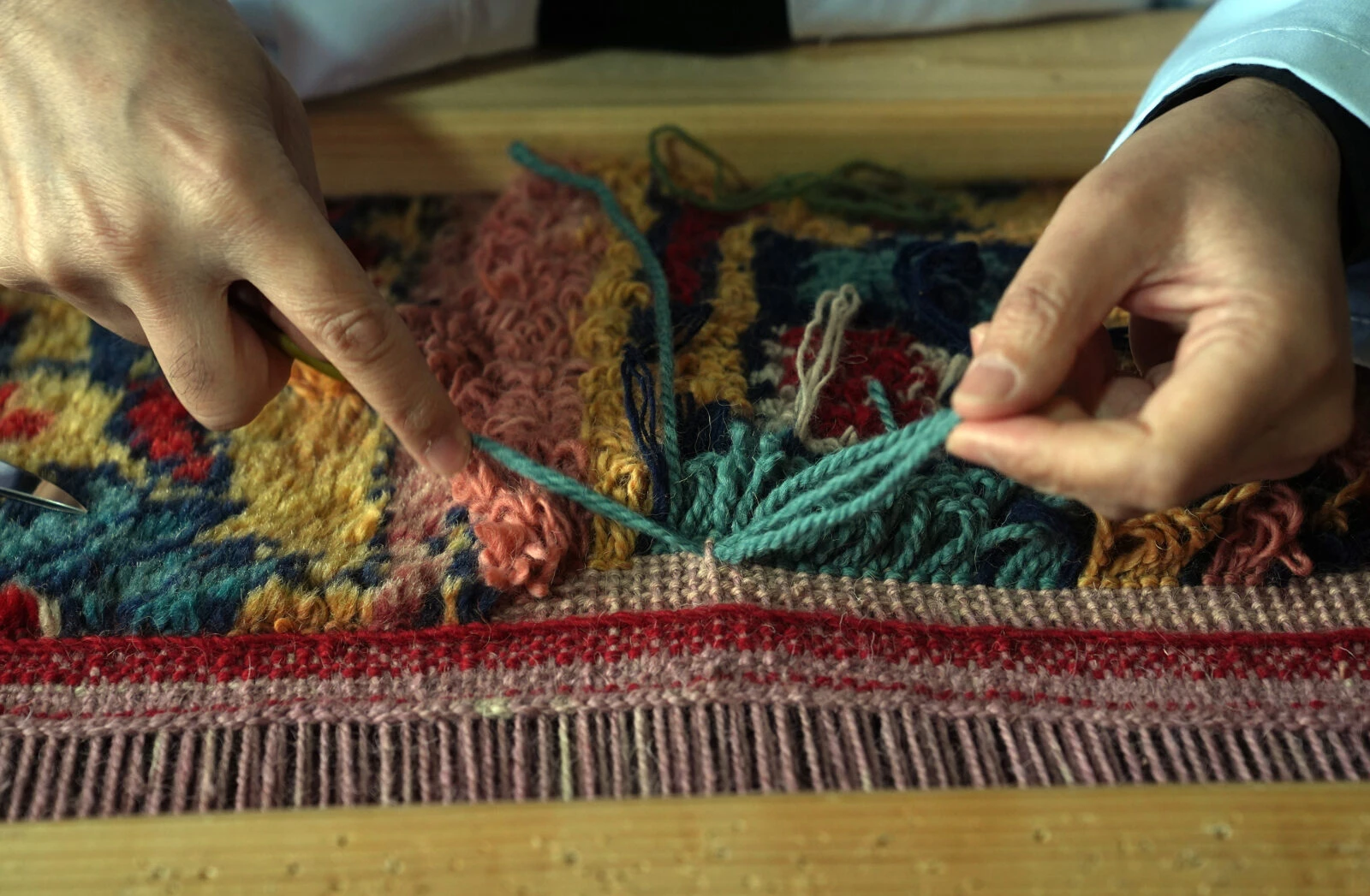 Restoration in progress on two 200-year-old carpets from the Ottoman palace, being prepared for exhibition in Istanbul.