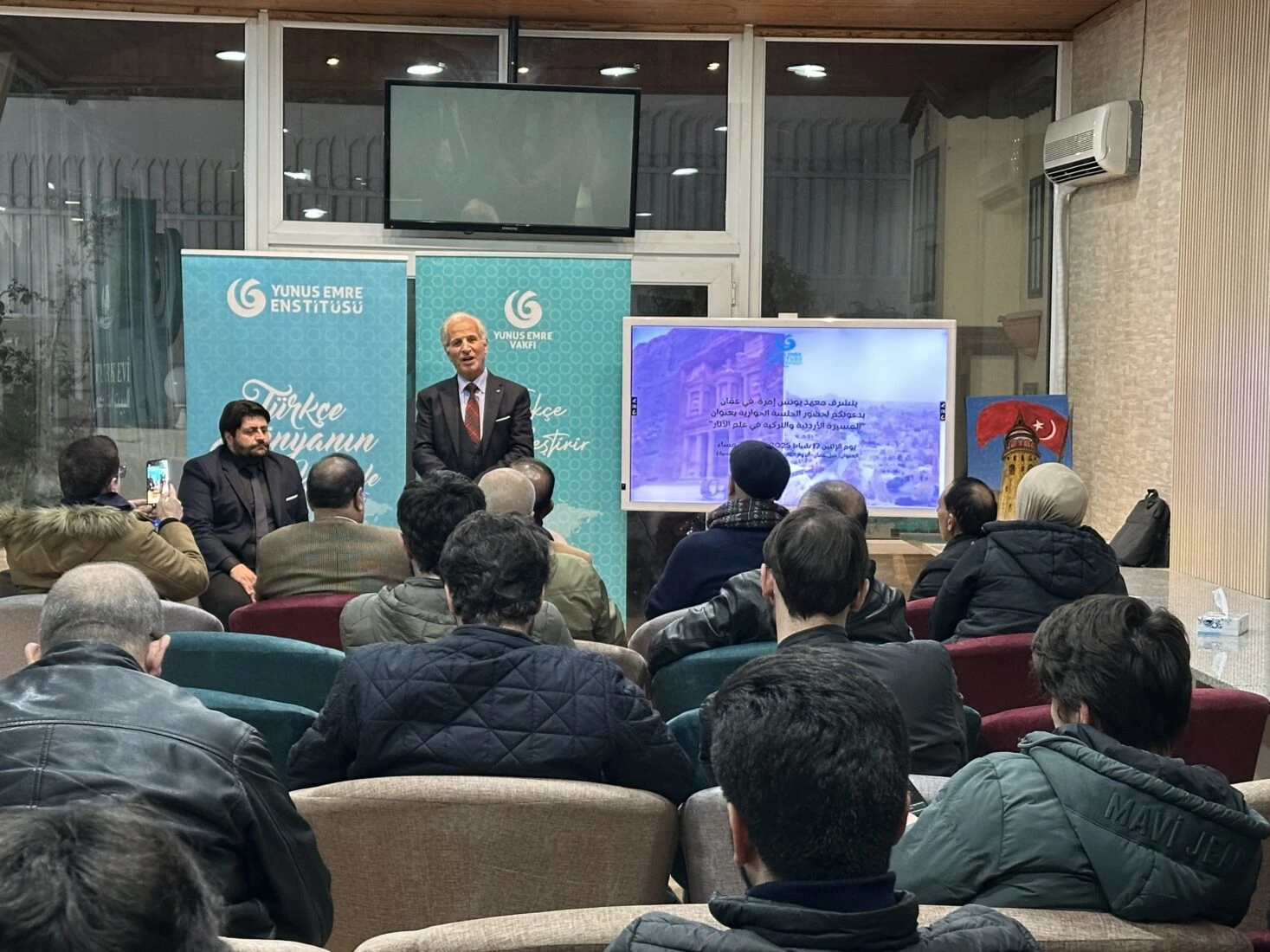 A panel discussion at the Yunus Emre Turkish Cultural Center in Amman, discussing historical artifacts in Türkiye and Jordan.