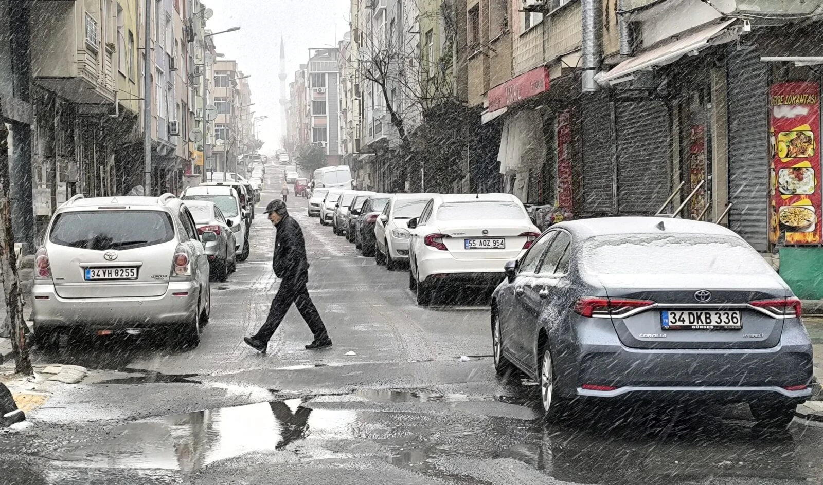 Man walks under snow as snowstorm in istanbul approaches