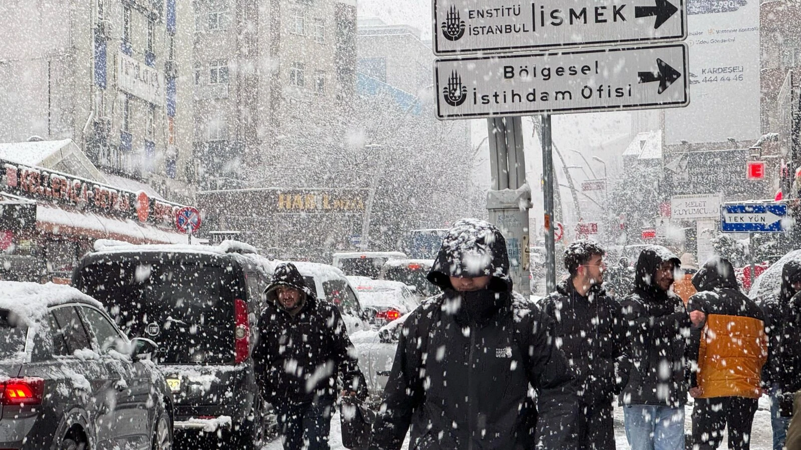 People walking on Istiklal Avenue in Istanbul as snow falls on February 19, 2025.