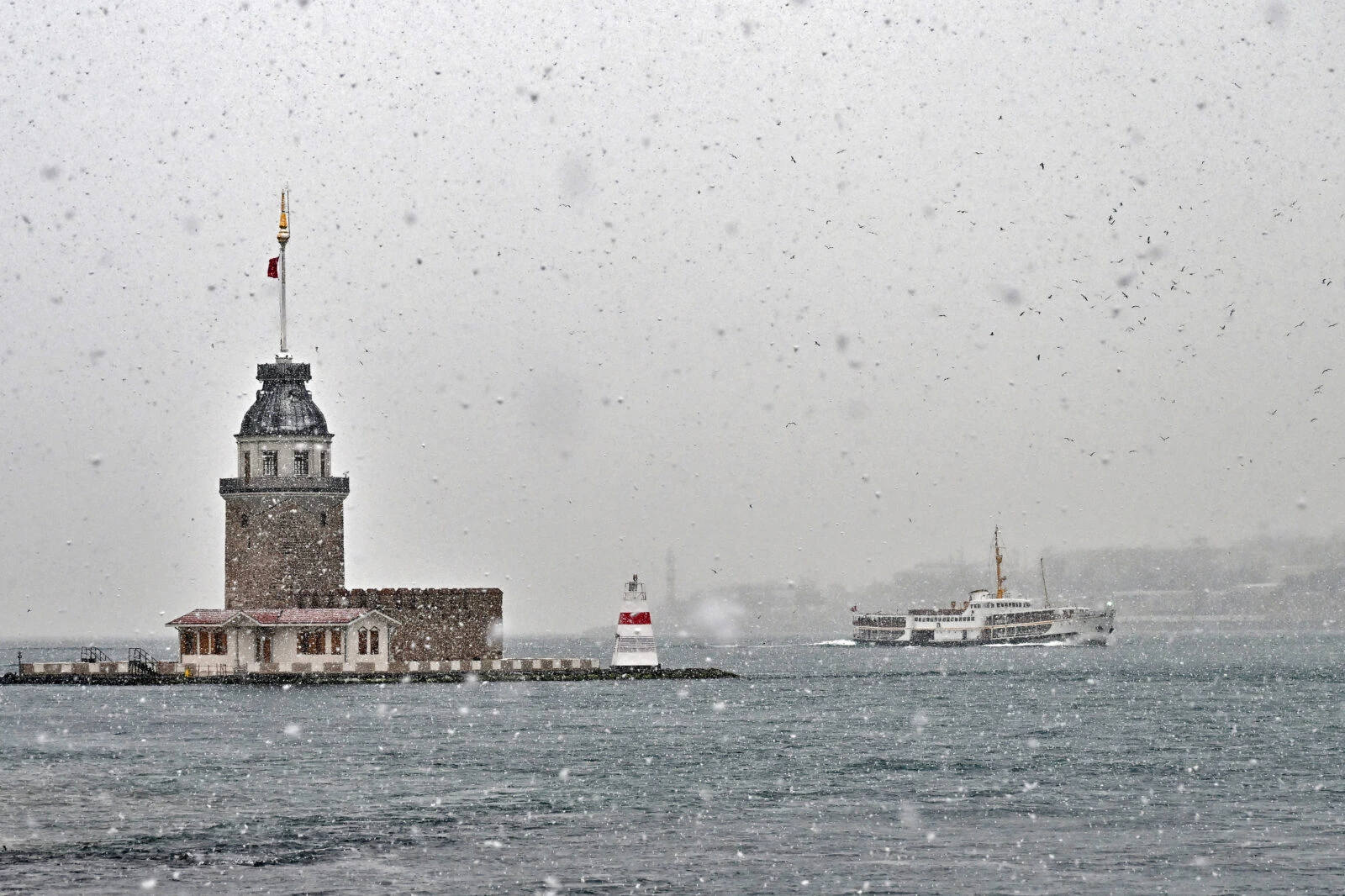 Maiden's Tower in Üsküdar, Istanbul, covered in snow on a winter day.