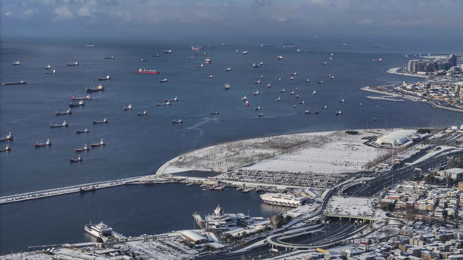 An aerial view of the Bosphorus ships as snowfall continues intermittently over Zeytinburnu, Istanbul.