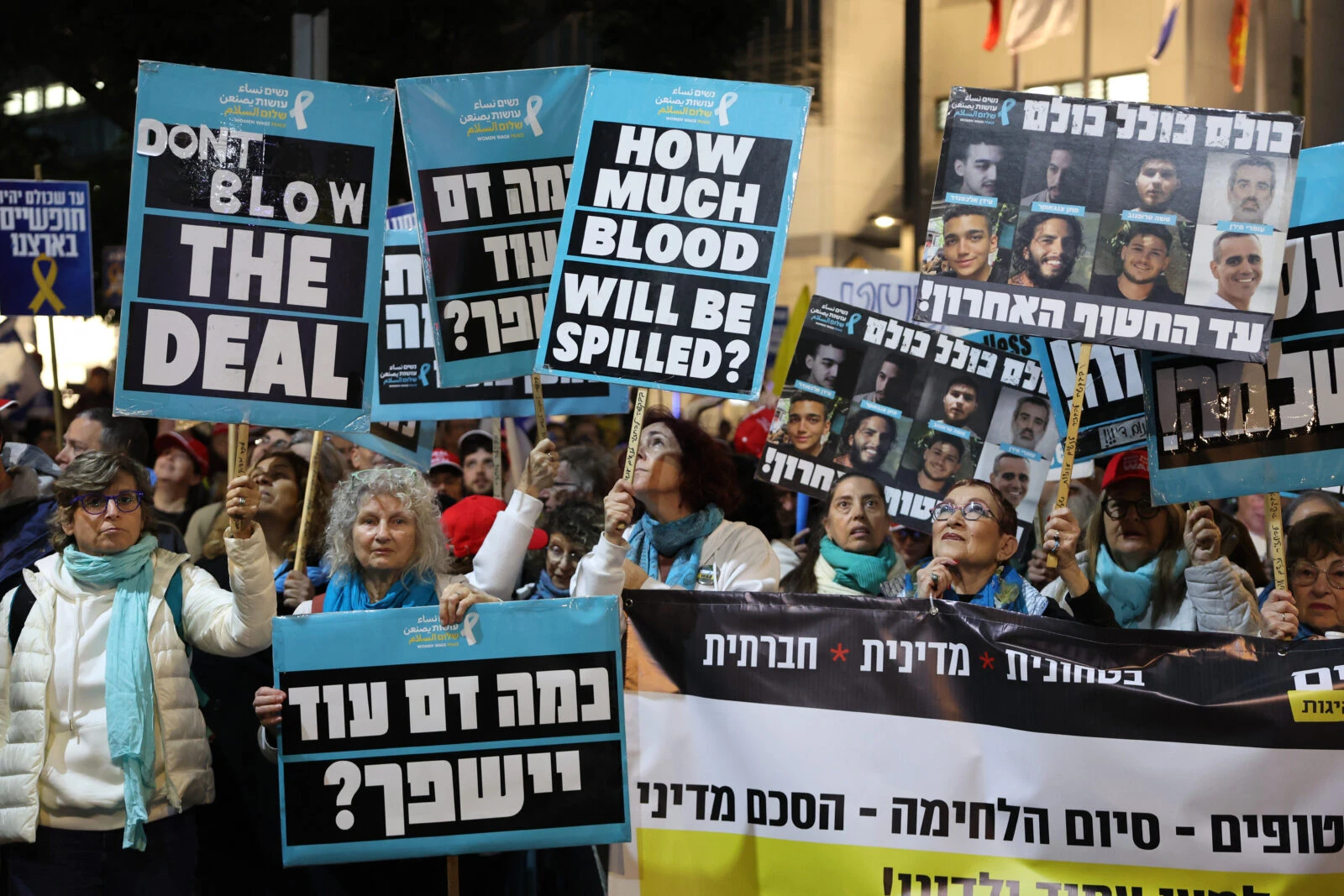 Demonstrators raise placards during a protest