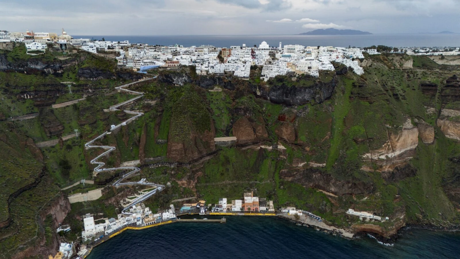 View of Fira and the old port on Santorini, Greece, following tremors on February 4, 2025, with people fleeing the island by ferry and plane.