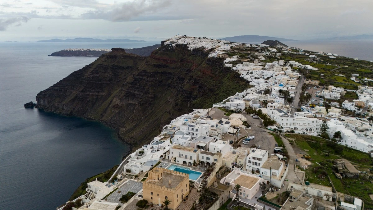 View of Fira and the old port on Santorini, Greece, following tremors on February 4, 2025, with people fleeing the island by ferry and plane.