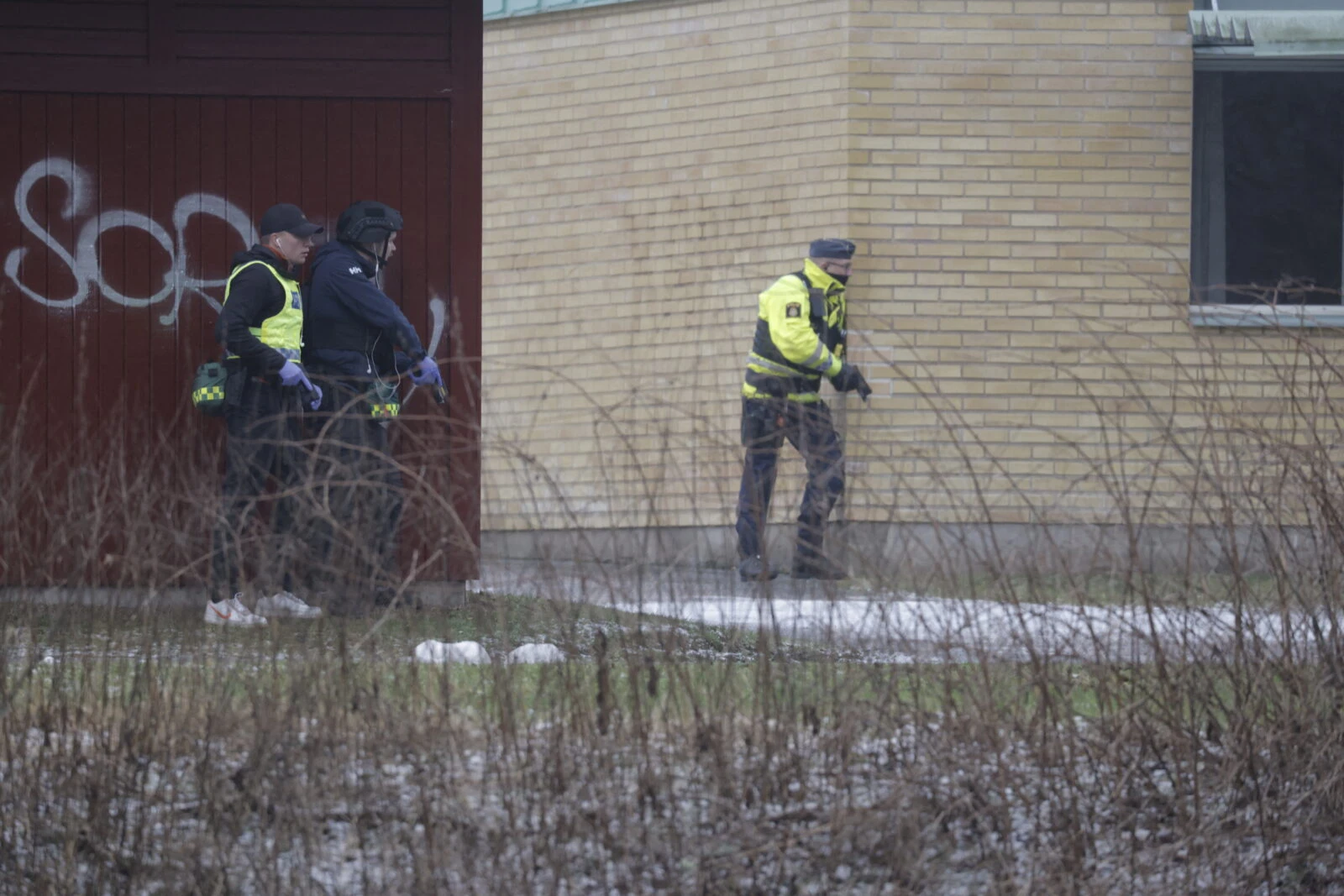 Police officers are seen at the Risbergska School, following reports of a serious violent crime.