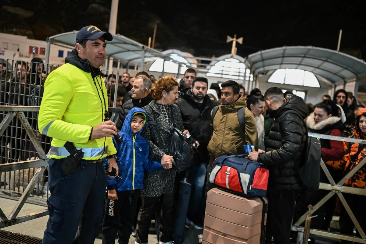 People waiting to board a ferry to leave Santorini, Greece, following recent earthquakes on February 4, 2025.