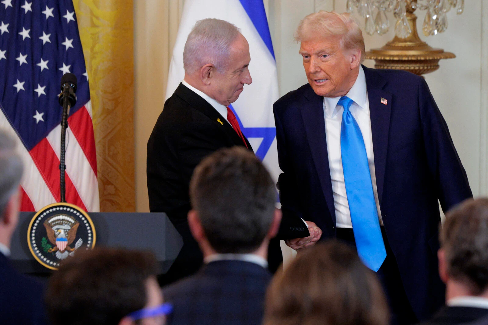 Photo shows U.S. President Donald Trump (R) and Israeli Prime Minister Benjamin Netanyahu shaking hands