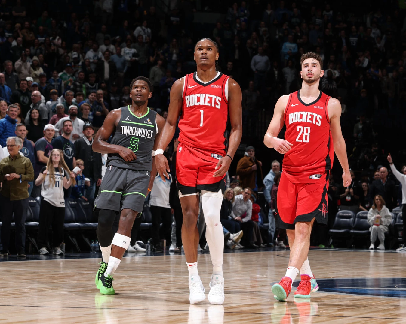 Amen Thompson (#1) and Alperen Sengun (#28) of the Houston Rockets with Anthony Edwards (#5) of the Minnesota Timberwolves