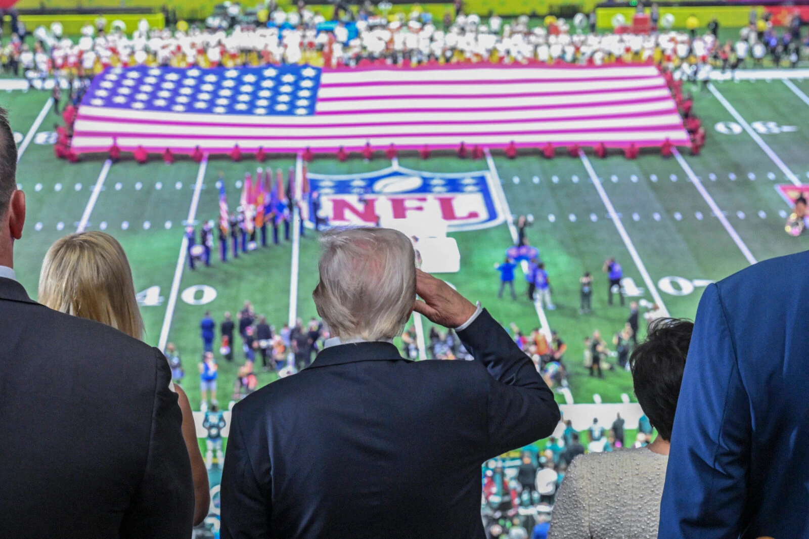 photo shows president trump saluting at a us flag in super bowl 2025