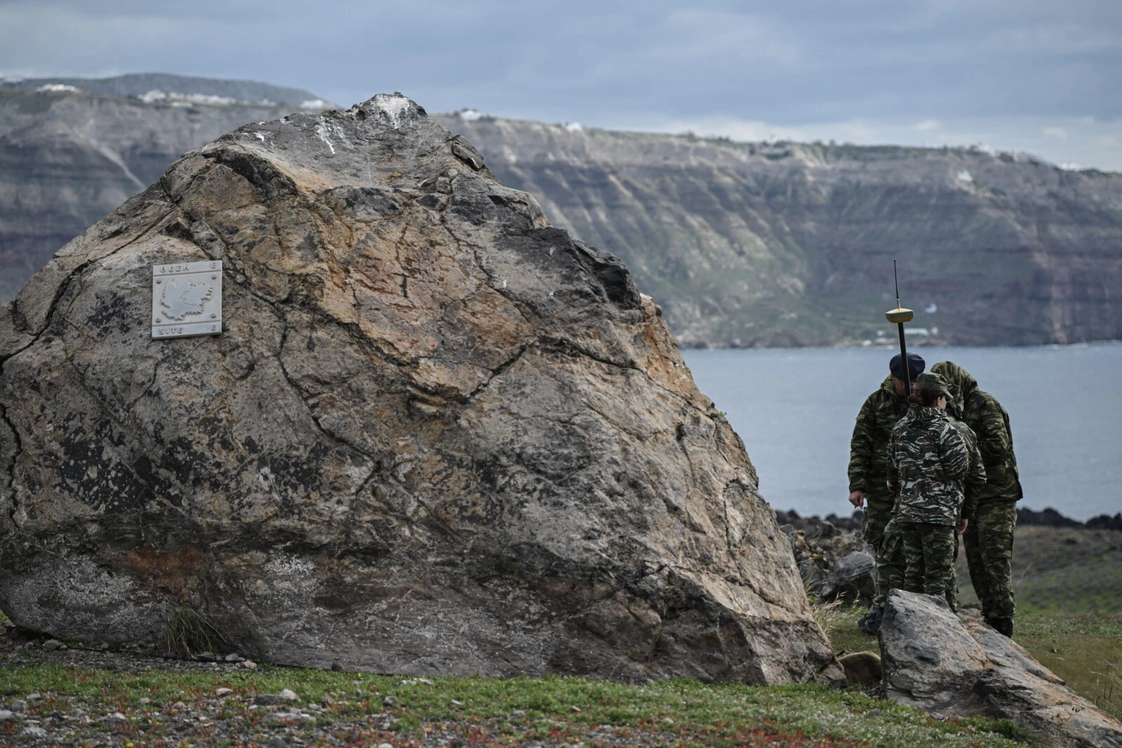 Members of Greece’s Military Geographical Service take measurements on Santorini’s volcanic island