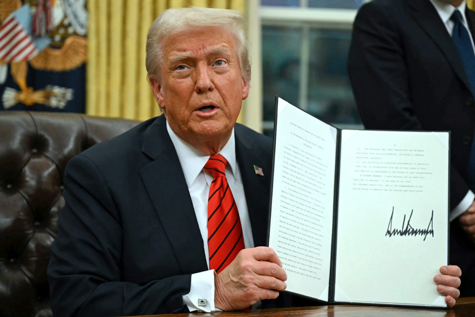 President Donald Trump signs an executive order