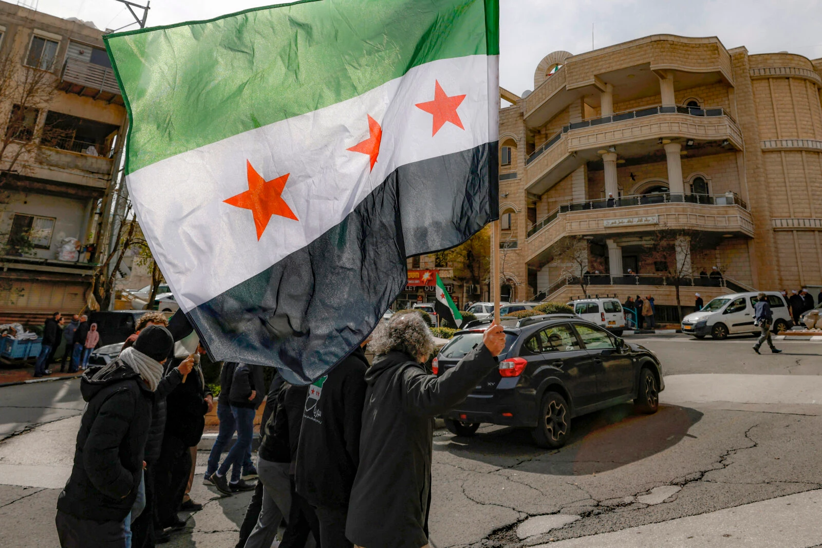 Photo shows a Syrian protest with new syrian flag