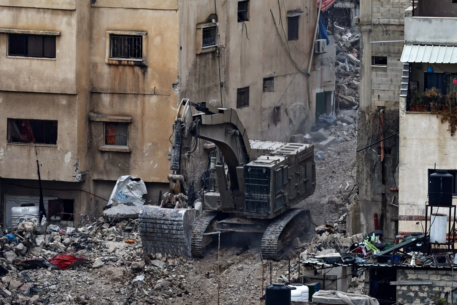 Photo shows Israeli bulldozer tearing up a street.