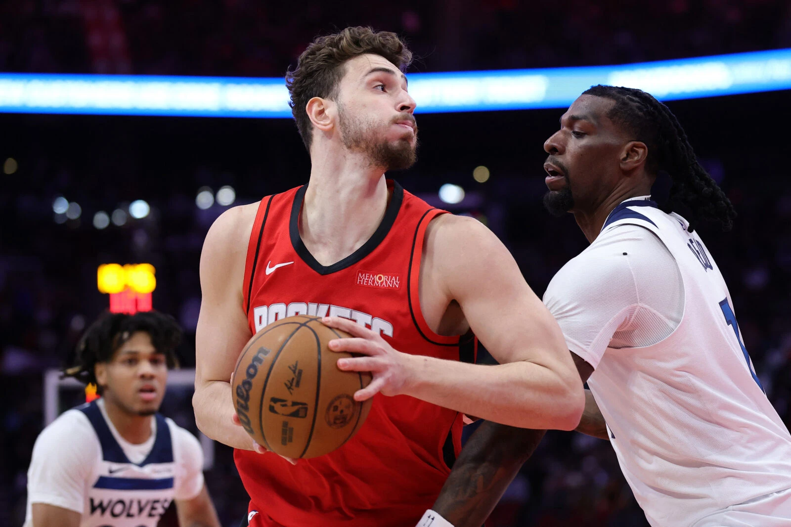 Alperen Sengun #28 of the Houston Rockets works against Naz Reid #11 of the Minnesota Timberwolves