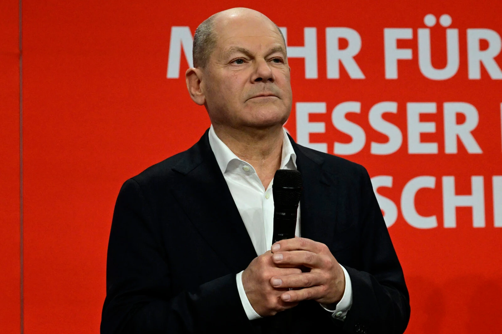 Photo shows German Chancellor and top candidate of the Social Democratic Party (SPD) Olaf Scholz holding the mic on stage during an election evening at Germany's Social Democratic Party's headquarters