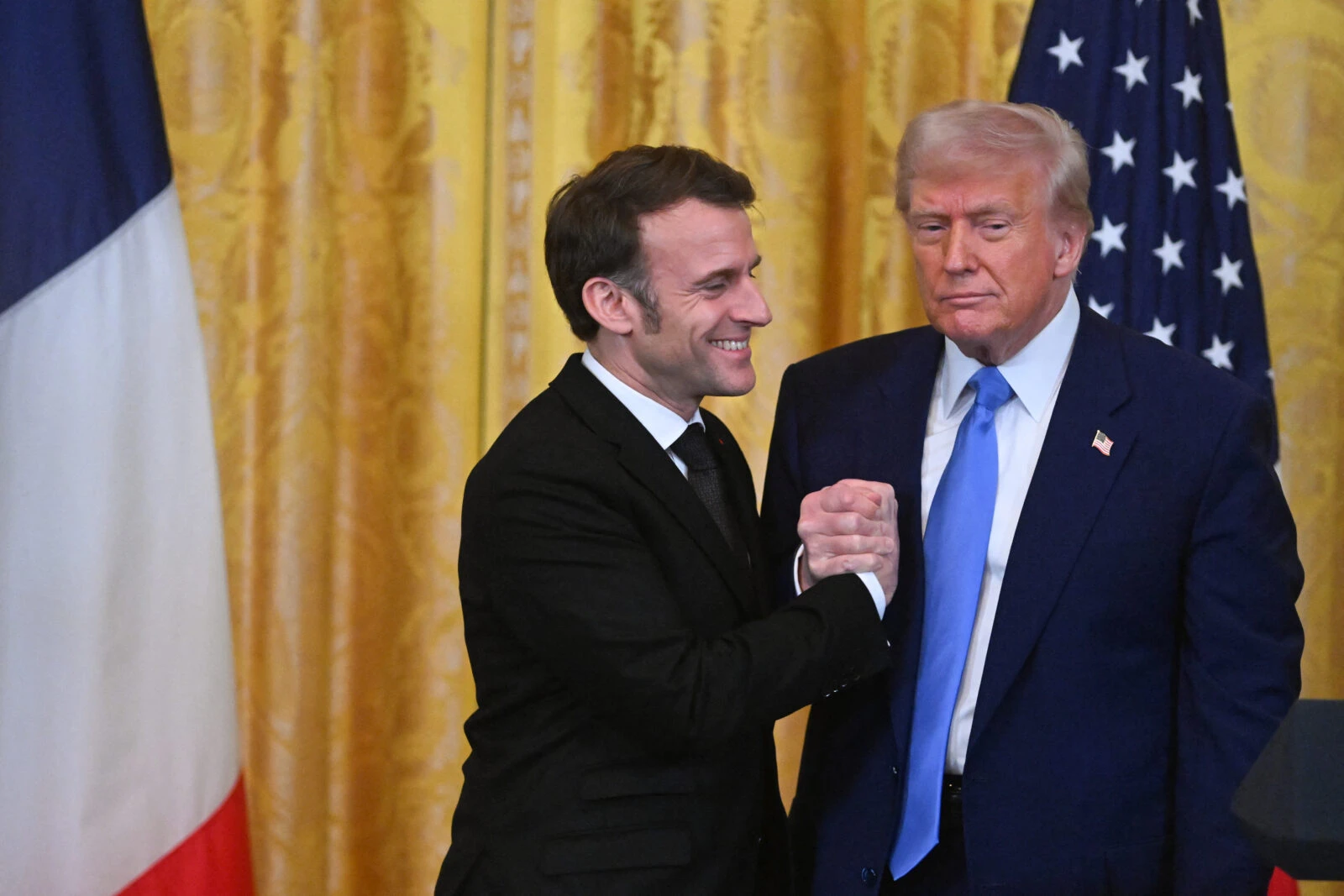 U.S. President Donald Trump (R) and French President Emmanuel Macron (L) seen shaking hands.