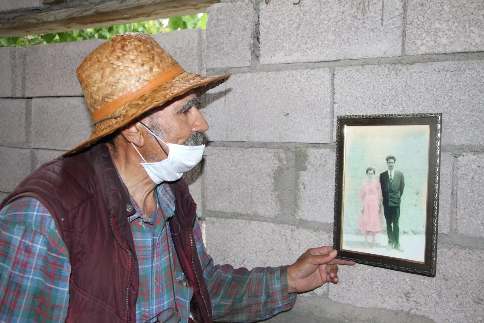 Ziya Abay, 86, looking at a photo of his late wife, lost in a traffic accident.